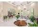 Bright living room with high ceilings, tile floors, large windows, and a unique cowhide rug at 30723 Reed Rd, Dade City, FL 33523