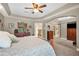 Bright main bedroom with a large bed, sitting area, and entry to en suite bathroom at 30723 Reed Rd, Dade City, FL 33523