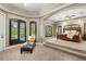 Luxury Primary bedroom boasts a private seating area, tray ceilings, and large windows at 30723 Reed Rd, Dade City, FL 33523