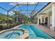 Stunning screened pool and hot tub with ample patio space, perfect for enjoying the Florida lifestyle at 30723 Reed Rd, Dade City, FL 33523