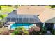 Stunning screened-in pool with a spa, surrounded by lush landscaping and a well-maintained yard at 30723 Reed Rd, Dade City, FL 33523