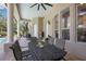 Covered patio with a dining set, perfect for enjoying meals by the pool at 30723 Reed Rd, Dade City, FL 33523
