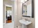 Powder room with a pedestal sink, a decorative mirror, and access to the office at 30723 Reed Rd, Dade City, FL 33523