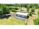 Large metal workshop with multiple garage doors and ample parking on a well-maintained lot at 30723 Reed Rd, Dade City, FL 33523