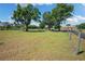 Spacious green yard with mature trees offering privacy and ample space at 30723 Reed Rd, Dade City, FL 33523