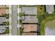 Aerial view of houses, highlighting roofs, driveways and landscaping on a well manicured street at 3096 Great Banyan Way, Wesley Chapel, FL 33543
