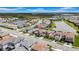 A high-angle aerial view of a neighborhood featuring scenic lakes, well-maintained homes, and green spaces at 3096 Great Banyan Way, Wesley Chapel, FL 33543