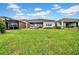 Spacious backyard with a lush lawn, enclosed patio and well manicured garden, offering serene outdoor space for relaxation and entertainment at 3096 Great Banyan Way, Wesley Chapel, FL 33543