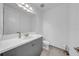 Clean and modern bathroom featuring a sleek vanity with ample storage, a large mirror, and a toilet for daily convenience at 3096 Great Banyan Way, Wesley Chapel, FL 33543