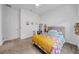 Cozy bedroom with neutral decor and a plush bed with colorful blankets and pillows, next to the door at 3096 Great Banyan Way, Wesley Chapel, FL 33543