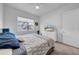 A brightly lit bedroom features neutral decor, a comfortable queen-sized bed, and a ceiling fan at 3096 Great Banyan Way, Wesley Chapel, FL 33543