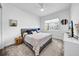 A well-lit bedroom features neutral decor, a comfortable queen-sized bed and a ceiling fan at 3096 Great Banyan Way, Wesley Chapel, FL 33543
