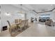Open-concept living and dining area with modern decor and plenty of natural light at 3096 Great Banyan Way, Wesley Chapel, FL 33543