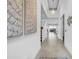 Bright, spacious hallway features tile flooring, modern lighting, and leads to the open-concept living spaces at 3096 Great Banyan Way, Wesley Chapel, FL 33543