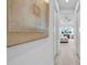 Hallway view leading into bedroom with ceiling fan and large window with view of the outdoors at 3096 Great Banyan Way, Wesley Chapel, FL 33543