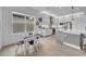 Modern kitchen features stainless steel appliances, white cabinetry, and a cozy breakfast nook at 3096 Great Banyan Way, Wesley Chapel, FL 33543