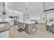 Modern kitchen featuring stainless steel appliances, a large island, and an open floor plan at 3096 Great Banyan Way, Wesley Chapel, FL 33543