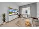 Well-lit living room area with tiled floors, a comfortable couch, and large TV for entertainment at 3096 Great Banyan Way, Wesley Chapel, FL 33543