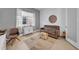 Comfortable living space features a brown sofa, neutral ottoman, and stylish decorations for a cozy feel at 3096 Great Banyan Way, Wesley Chapel, FL 33543