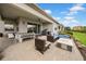 An expansive patio features comfortable seating, dining area, and outdoor kitchen, perfect for entertaining and relaxing in style at 3096 Great Banyan Way, Wesley Chapel, FL 33543