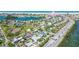 Beautiful St. Pete Beach aerial view showcases lush homes, tennis courts, and scenic intercoastal waterways at 3210 E Maritana Dr, St Pete Beach, FL 33706