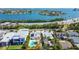 Stunning aerial view of home with pool and bay views, ideal for waterfront living at 3210 E Maritana Dr, St Pete Beach, FL 33706