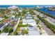 Aerial view of a home with a pool and patio, located in a neighborhood near a bay and the historic Don CeSar Hotel at 3210 E Maritana Dr, St Pete Beach, FL 33706