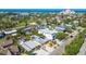 Wide aerial view showcases the home's pool and patio, situated near waterfront, tennis courts, and the Don CeSar Hotel at 3210 E Maritana Dr, St Pete Beach, FL 33706
