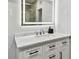 Well lit bathroom featuring a sleek white vanity, drawers with black handles and a bright, framed mirror at 3210 E Maritana Dr, St Pete Beach, FL 33706