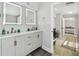 Beautiful bathroom featuring double sink vanity, modern lighting, and easy access to bedroom at 3210 E Maritana Dr, St Pete Beach, FL 33706