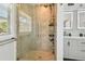 Updated bathroom shower with tile surround, river rock base, and modern shower fixture at 3210 E Maritana Dr, St Pete Beach, FL 33706
