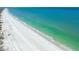 Scenic aerial view of a white sand beach with calm turquoise waters in St. Pete Beach, Florida at 3210 E Maritana Dr, St Pete Beach, FL 33706