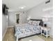 Serene bedroom with nautical-themed bedding, bright natural light, and tiled flooring at 3210 E Maritana Dr, St Pete Beach, FL 33706