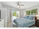 Bedroom with walkout to pool area, light gray walls, ceiling fan, and built-in storage at 3210 E Maritana Dr, St Pete Beach, FL 33706