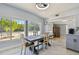 Bright dining room with a modern table and large windows with a front yard view at 3210 E Maritana Dr, St Pete Beach, FL 33706