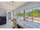 Spacious dining room with modern décor and large windows overlooking palm trees at 3210 E Maritana Dr, St Pete Beach, FL 33706