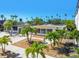 Beautiful home exterior with palm trees and walkways to front entry at 3210 E Maritana Dr, St Pete Beach, FL 33706