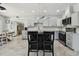 Modern eat-in kitchen features stainless appliances, a center island, and updated cabinetry and countertops at 3210 E Maritana Dr, St Pete Beach, FL 33706