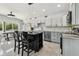 Modern eat-in kitchen features stainless appliances, a center island, and updated cabinetry and countertops at 3210 E Maritana Dr, St Pete Beach, FL 33706