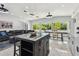 Open concept living space with a center island, tile flooring and tropical views from the large windows at 3210 E Maritana Dr, St Pete Beach, FL 33706