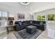 Cozy living room featuring plush seating, decorative pillows, and a stylish area rug and tiled flooring at 3210 E Maritana Dr, St Pete Beach, FL 33706
