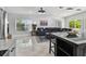 Open concept living space with tile flooring and views from the large windows at 3210 E Maritana Dr, St Pete Beach, FL 33706