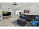 Comfortable living area with a large sectional sofa, TV, and stylish decor on tiled flooring at 3210 E Maritana Dr, St Pete Beach, FL 33706