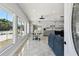 Bright living space with a dining area, tile floors, and kitchen access at 3210 E Maritana Dr, St Pete Beach, FL 33706