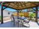 Enjoy outdoor dining under this covered patio with a view of the landscaped backyard at 3210 E Maritana Dr, St Pete Beach, FL 33706