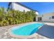 This kidney shaped pool sits among beautiful tropical landscaping in a fenced backyard, providing a relaxing private oasis at 3210 E Maritana Dr, St Pete Beach, FL 33706