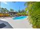 Beautiful pool and patio area surrounded by lush landscaping, offering a private outdoor oasis at 3210 E Maritana Dr, St Pete Beach, FL 33706
