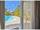 View of the beautiful pool and patio area from the bedroom walkout at 3210 E Maritana Dr, St Pete Beach, FL 33706