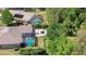 Aerial view of two pools, a patio, and an outdoor seating area surrounded by lush greenery at 3212 Sunset Lakes Blvd, Land O Lakes, FL 34638