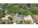 Stunning aerial view of homes, lush landscaping, pools, and a serene pond, offering a peaceful and private retreat at 3212 Sunset Lakes Blvd, Land O Lakes, FL 34638
